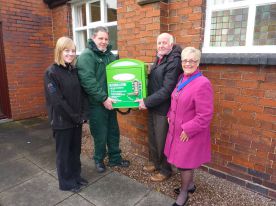 Staffordshire's Alliance handing over a defribrillator