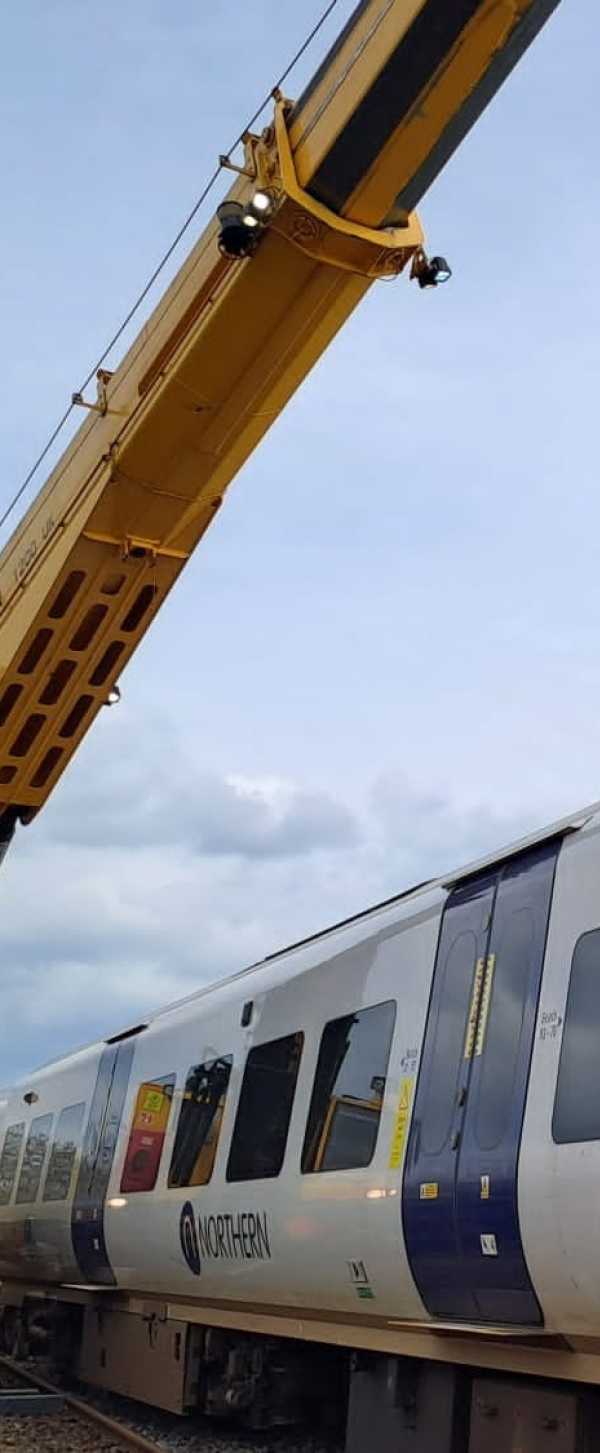 A 1200 Kirow crane rerailing a derailed passenger train