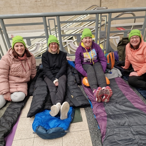 A group of women sleeping in a train station for charity