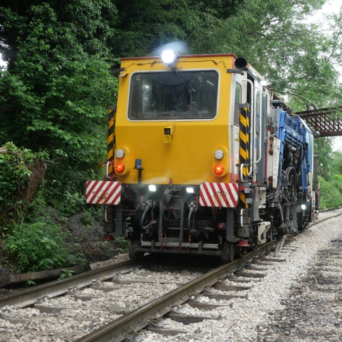 Beaver tamper tamping on the railway
