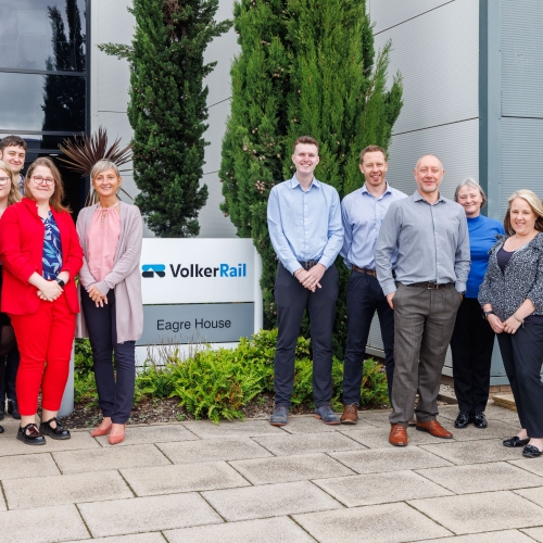 group of employees outside next to a VolkerRail sign