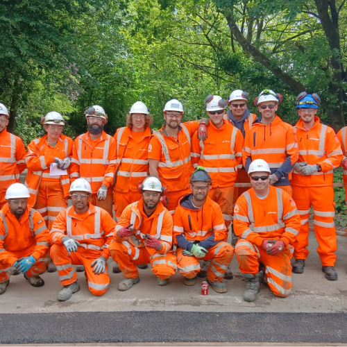 group of employees in PPE posing for picture