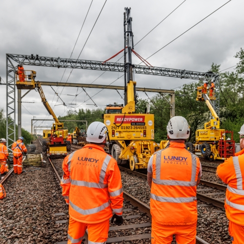 people with their back to the camera showing their company names