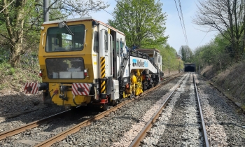 A lightweight Beaver tamper tamping a track