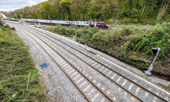 a picture of new train laid and a train in the background