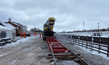 A Kirow crane being loaded onto a lorry