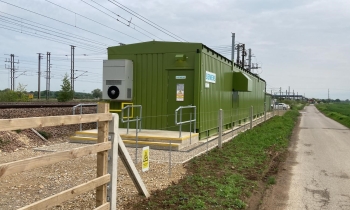 picture of a power supply box that is green near track