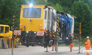A Beaver tamper being dropped onto track