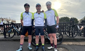 Three cyclists posing for a picture