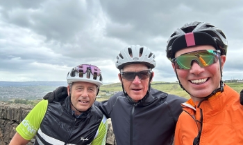 Three cyclists posing for a picture