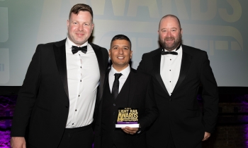 people holding the global light rail award