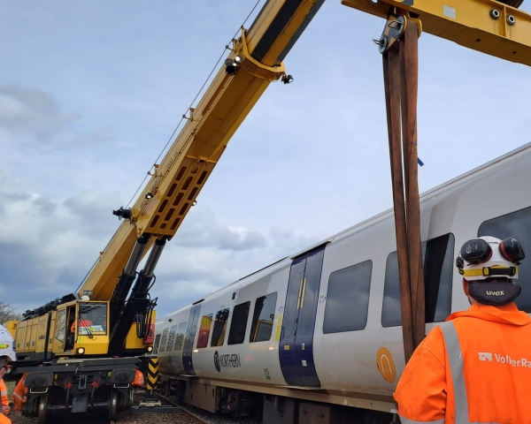 A 1200 Kirow crane rerailing a derailed passenger train