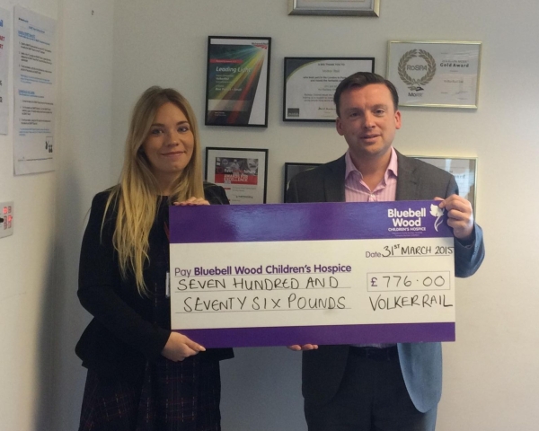 A charity cheque being handed over