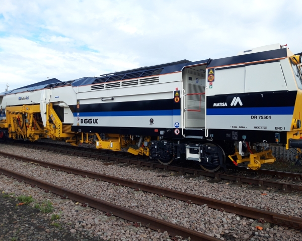 A Matisa tamper tamping on the railway tracks