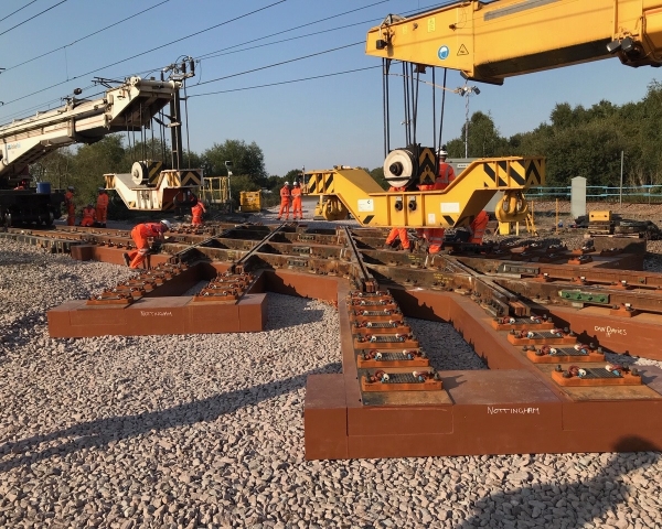 Two Kirow cranes installing a diamond crossing