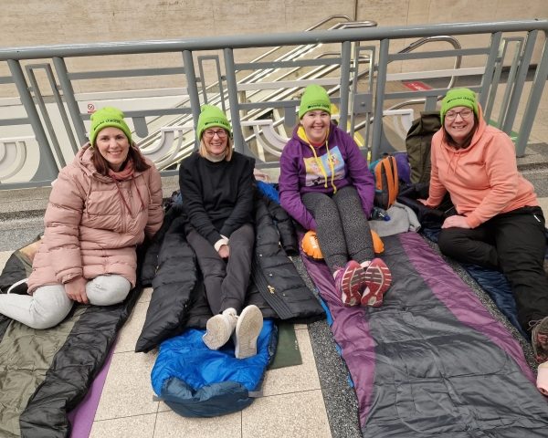 A group of women sleeping in a train station for charity
