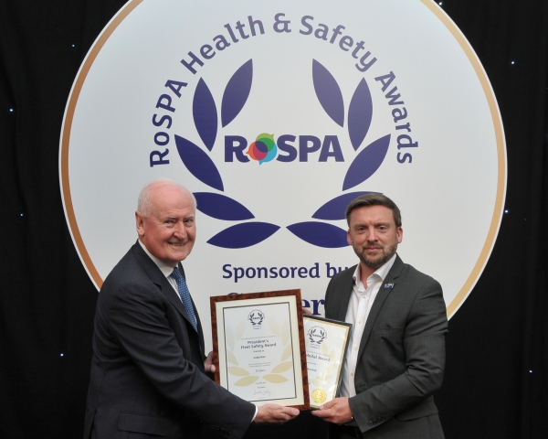 A man receiving a safety award on stage