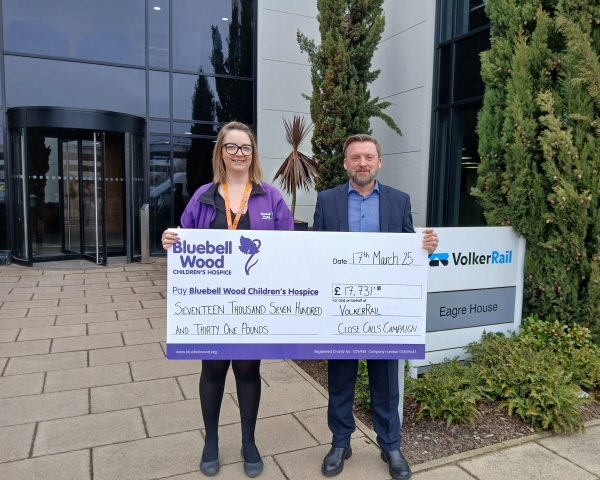man and women holding a large cheque