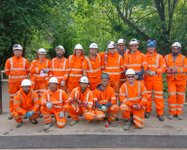 group of employees in PPE posing for picture