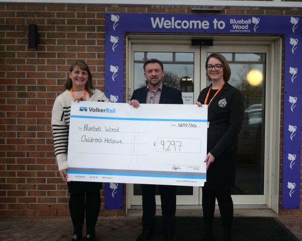 Handing over a large cheque to Bluebell Wood Children's hospice 