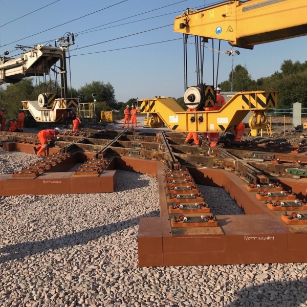 Two Kirow cranes installing a diamond crossing