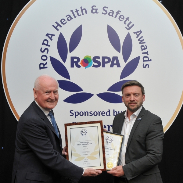 A man receiving a safety award on stage