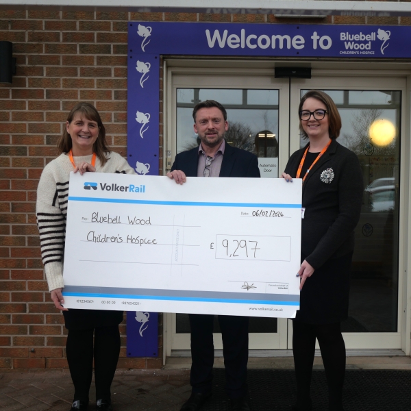 Handing over a large cheque to Bluebell Wood Children's hospice 