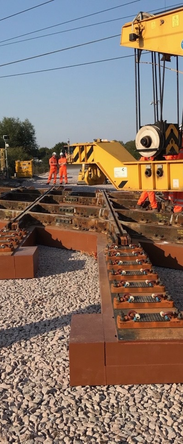 Two Kirow cranes installing a diamond crossing