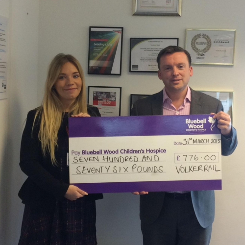 A charity cheque being handed over