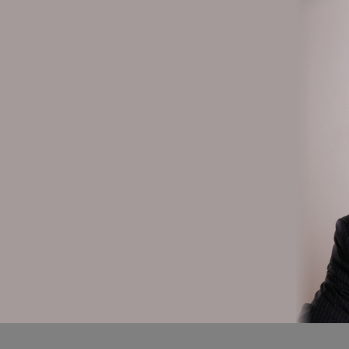 A man in a suit smiling