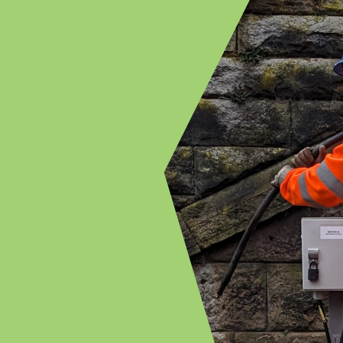A man in orange PPE moving a telecoms cable