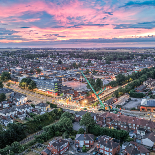 arieal image with red sky of crane removing bridge parts