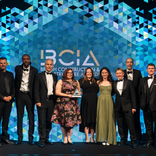 Group of people on stage collecting an award