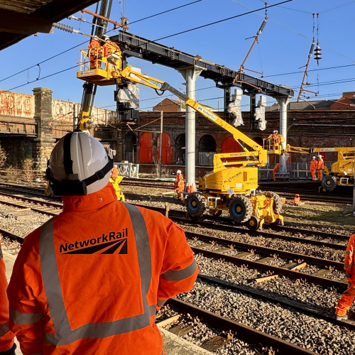 VolkerRail logo and Network Rail logo on back of PPE with signalling installation works in the distance