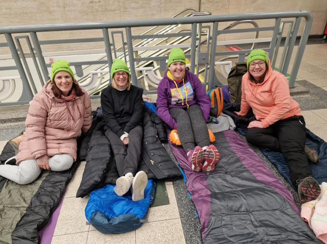 A group of women sleeping in a train station for charity