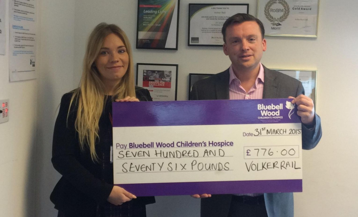 A charity cheque being handed over