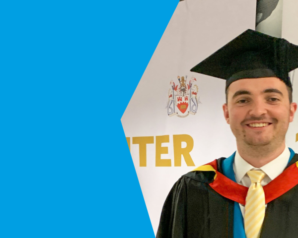 A young man in his graduation cap and gown