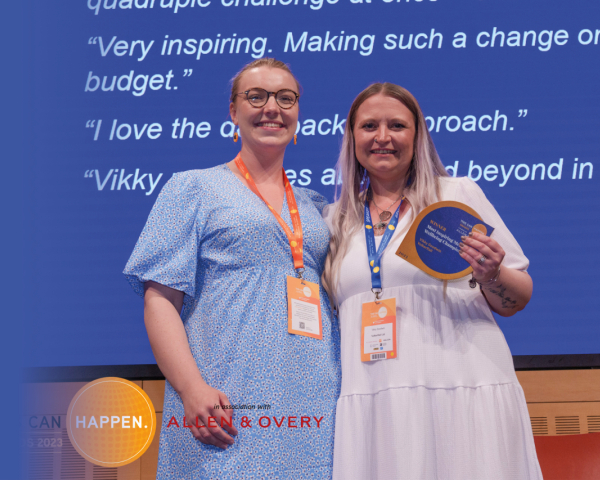 Two women smiling after receiving an award