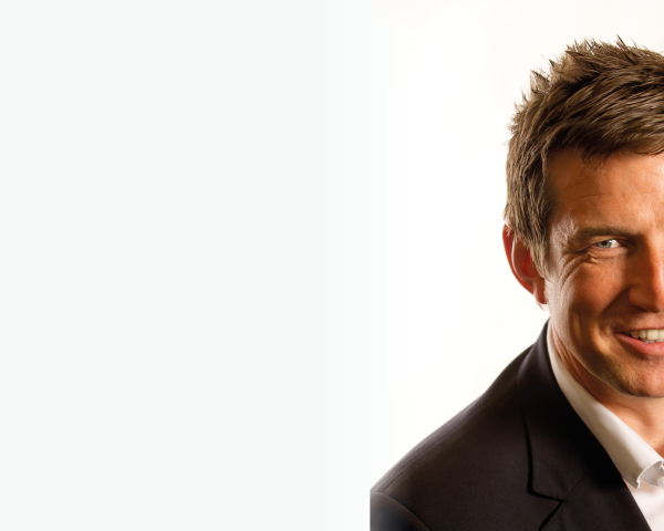 A man in a suit smiling