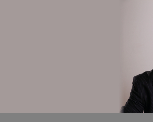 A man in a suit smiling