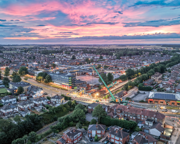 arieal image with red sky of crane removing bridge parts