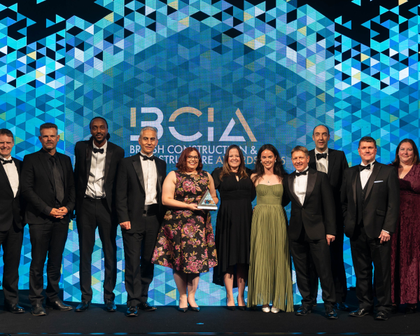 Group of people on stage collecting an award