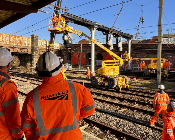 VolkerRail logo and Network Rail logo on back of PPE with signalling installation works in the distance