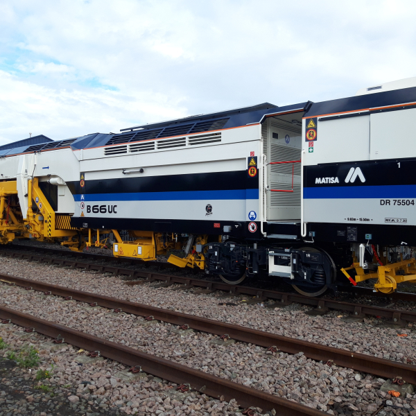 A Matisa tamper tamping on the railway tracks